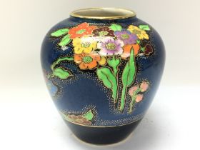 A Crown Devon Art Deco floral vase, 11cm tall. No