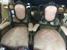 A pair of Edwardian open armchairs with floral pink backs and seats together with a pair of Matching