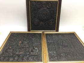 Three framed embossed metal plaques depicting budd