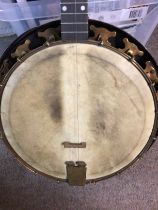 A cased banjo in need of repair.