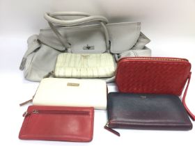 A collection of purses and bags including designer