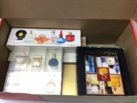 A collection of miniature perfumes including Estee