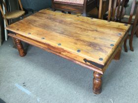 A stained pine coffee table, approx 110cm x 60cm x 40cm. Shipping category D.