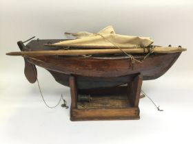 A scratch built wooden model of a sailing boat, ap