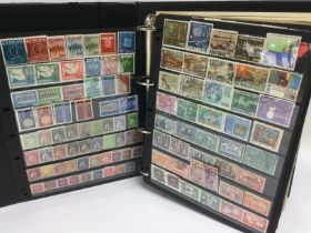 Two crates containing eleven albums of various world postage stamps including USA, Portugal,