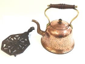 An arts and crafts hammered copper kettle with turned wood handle by Henry Loveridge circa 1910.