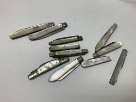 Eleven silver and mother of Pearl pen knives.