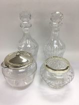 A glass biscuit barrell with a silver lid, two gla