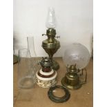 A brass oil lamp with shade and assorted parts