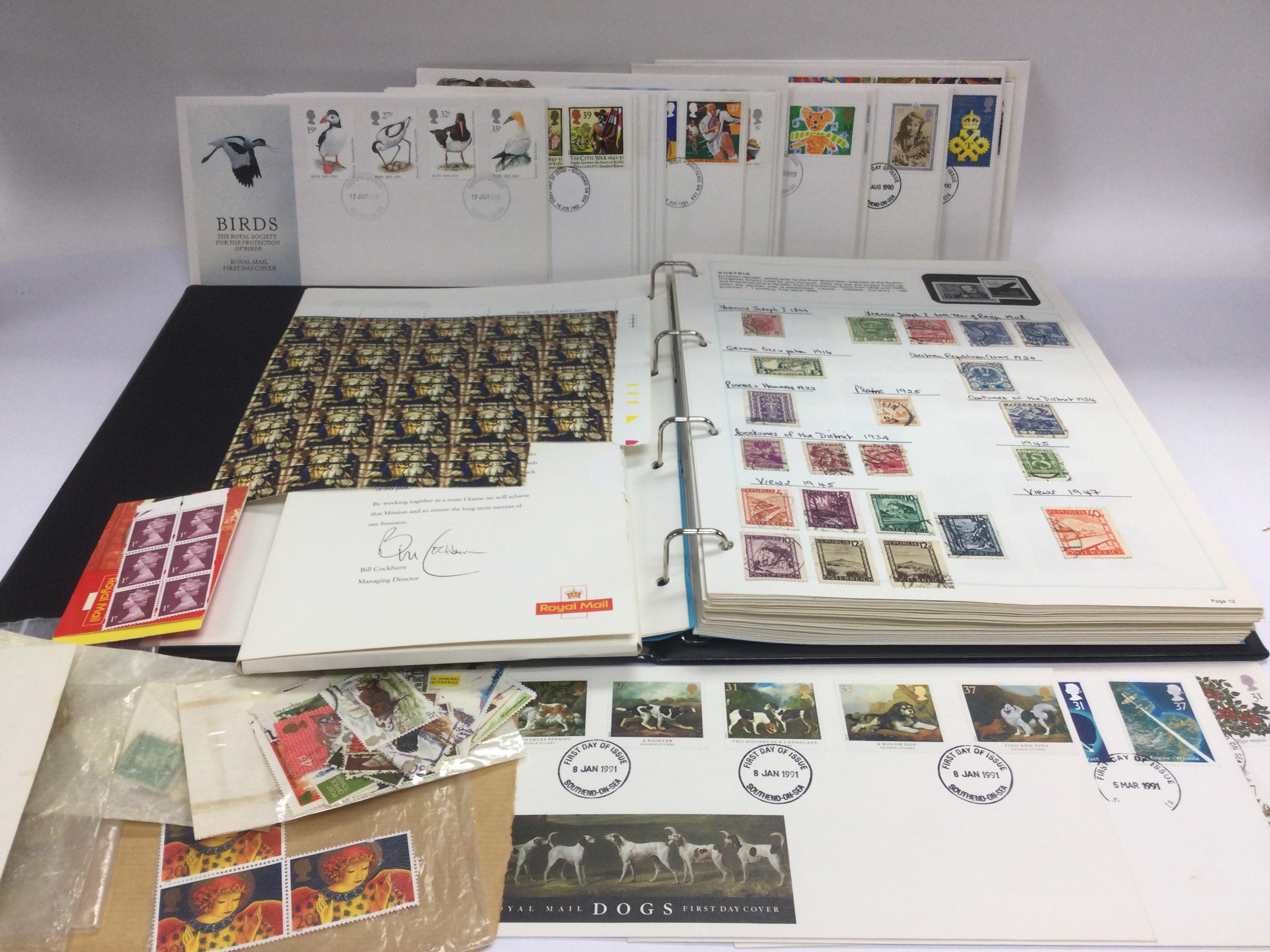 An album of world postage stamps and a small colle