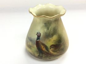 A small Royal Worcester vase with painted decorati