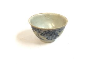 A blue and white floral tea bowl that was recovered from the Chinese trading junk that sank in 1822.