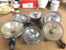 A collection of vintage car spot lamps, postage ca