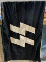 A German SS flag, stamped to the lanyard Berlin Waffen SS and dated 1943, 93cm x 60cm.