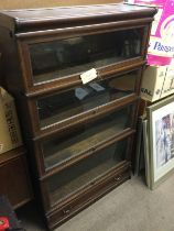 A Globe Wernick four tier bookcase, approx 86.5cm x 30cm x 46.5cm. Shipping category D.