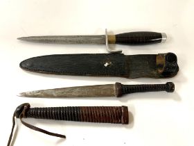 A leather bound dagger together with a dagger and