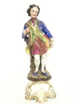 A Porcelain figure of a Gentleman resting on a tre