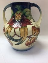 A Moorcroft vase with twin handles decorated in th