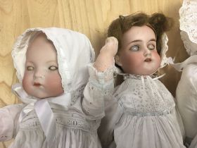 Three German bisque head dolls together with pram and star baby cars Magazine.