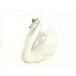 A Porcelain Lladro swan figure, 18cm tall. no obvi