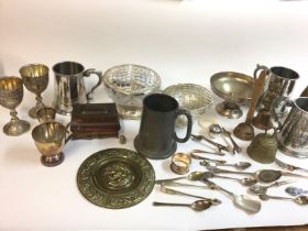 A box containing an assortment of silver plate ite