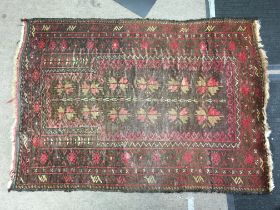 A small brown and red rug , dimensions 115x84cm.-