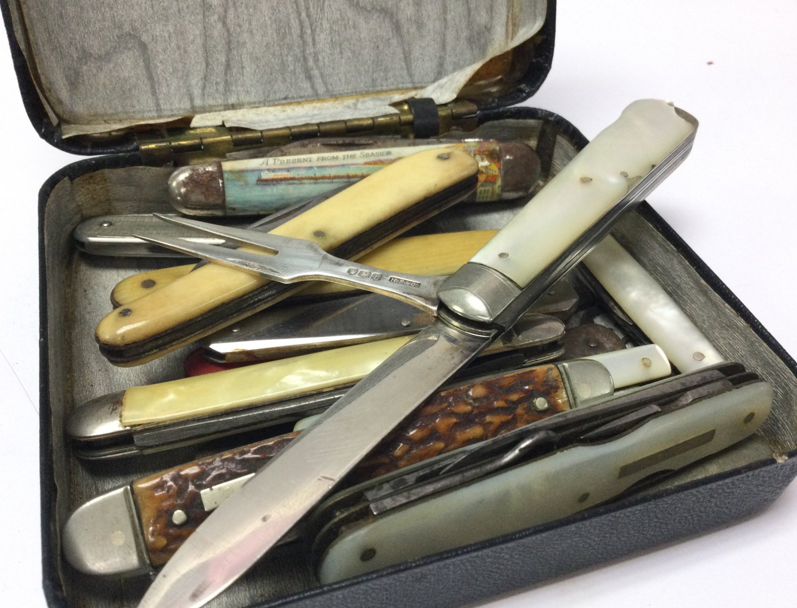 A collection of vintage penknives including a silv