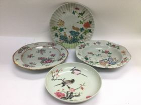 Four Oriental plates, various designs, largest app