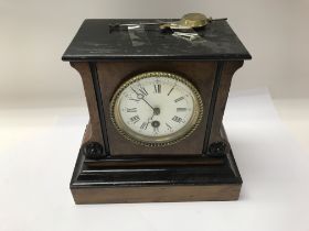 A late Victorian walnut clock. Approx 23x21cm.