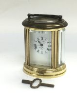 A small brass cased carriage clock with key. Shipp