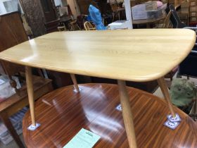 A Ercol dinning table with four matching chairs .