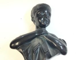 A sculpture of a young childâ€™s bust made of terr