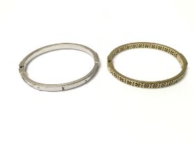 Two bangles by fossil. Approximately 7cm diameter.