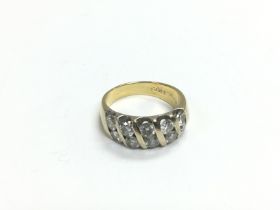 An 18ct gold ring set with ten diamonds, G-H colou