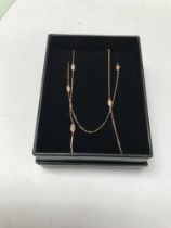 A 14ct rose gold necklace set with diamond and ena