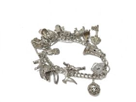 A silver charm bracelet with a number of charms. 5