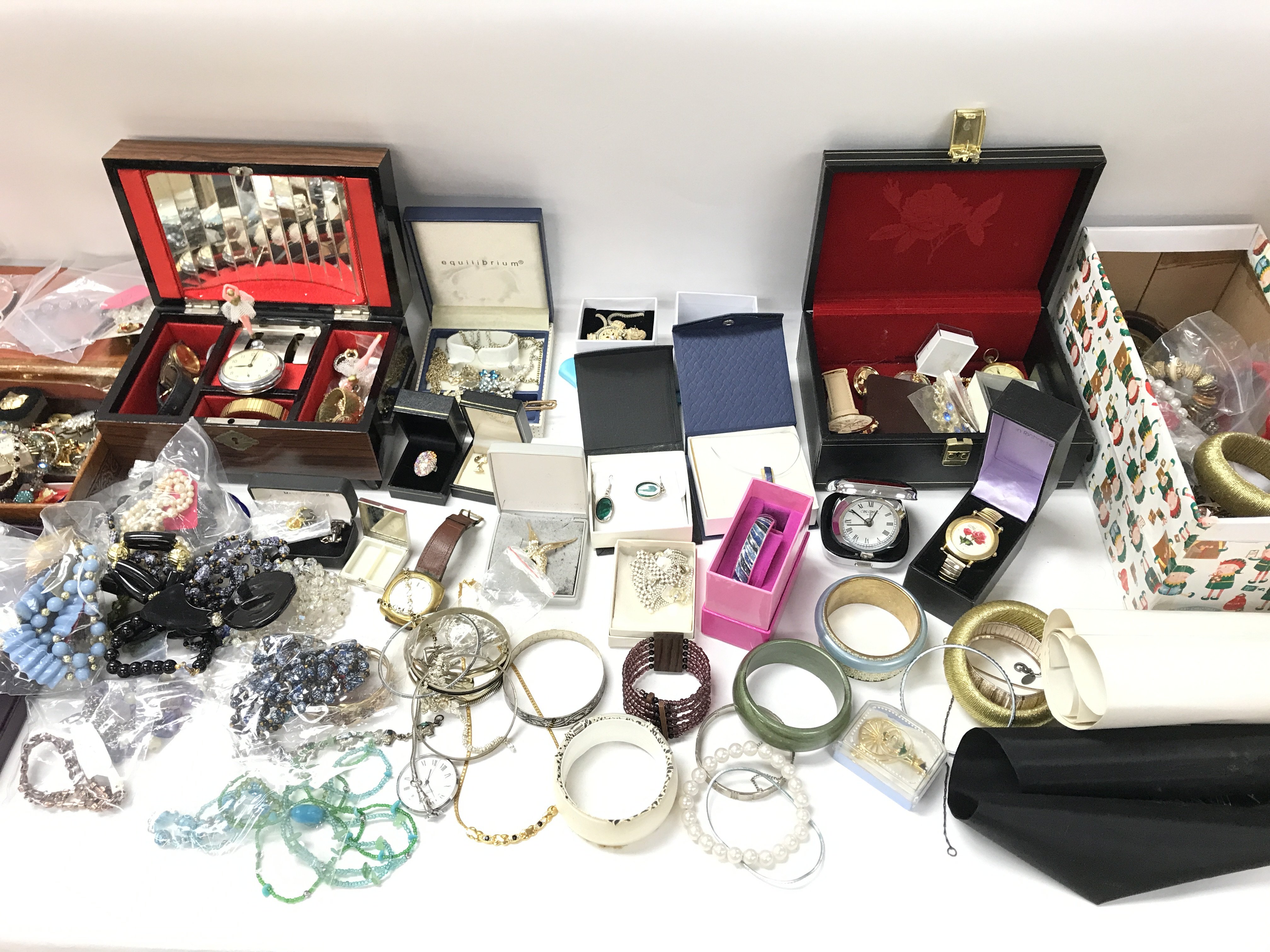 A large collection of assorted costume jewellery including brooches necklaces etc.