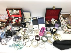 A large collection of assorted costume jewellery including brooches necklaces etc.