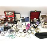 A large collection of assorted costume jewellery including brooches necklaces etc.
