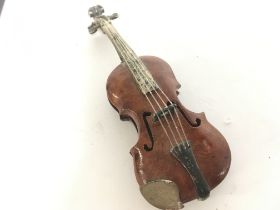 A sterling silver and wooden violin, postage categ