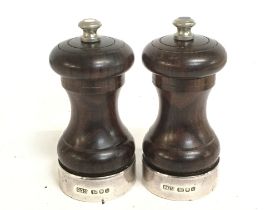 A pair of silver hallmarked and rosewood salt and