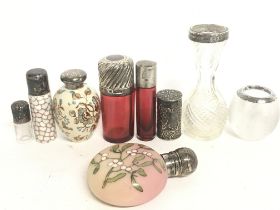 A collection of silver hallmarked topped glass bot