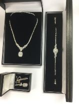 A white gold and diamond three piece jewellery set