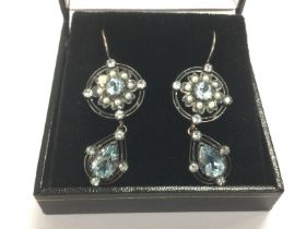 A pair of vintage style drop earrings set with top
