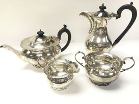 A four piece silver tea set with cream jug and sug