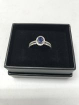 A 14ct white gold diamond and sapphire solitaire r