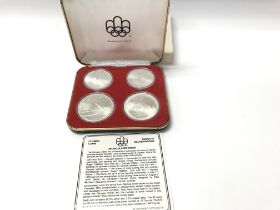 A 1976 Silver Olympic coin set. Postage A