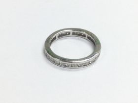 An 18ct white gold eternity ring, approx size K-L