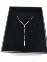 A 14ct rose gold necklace set with a single diamon
