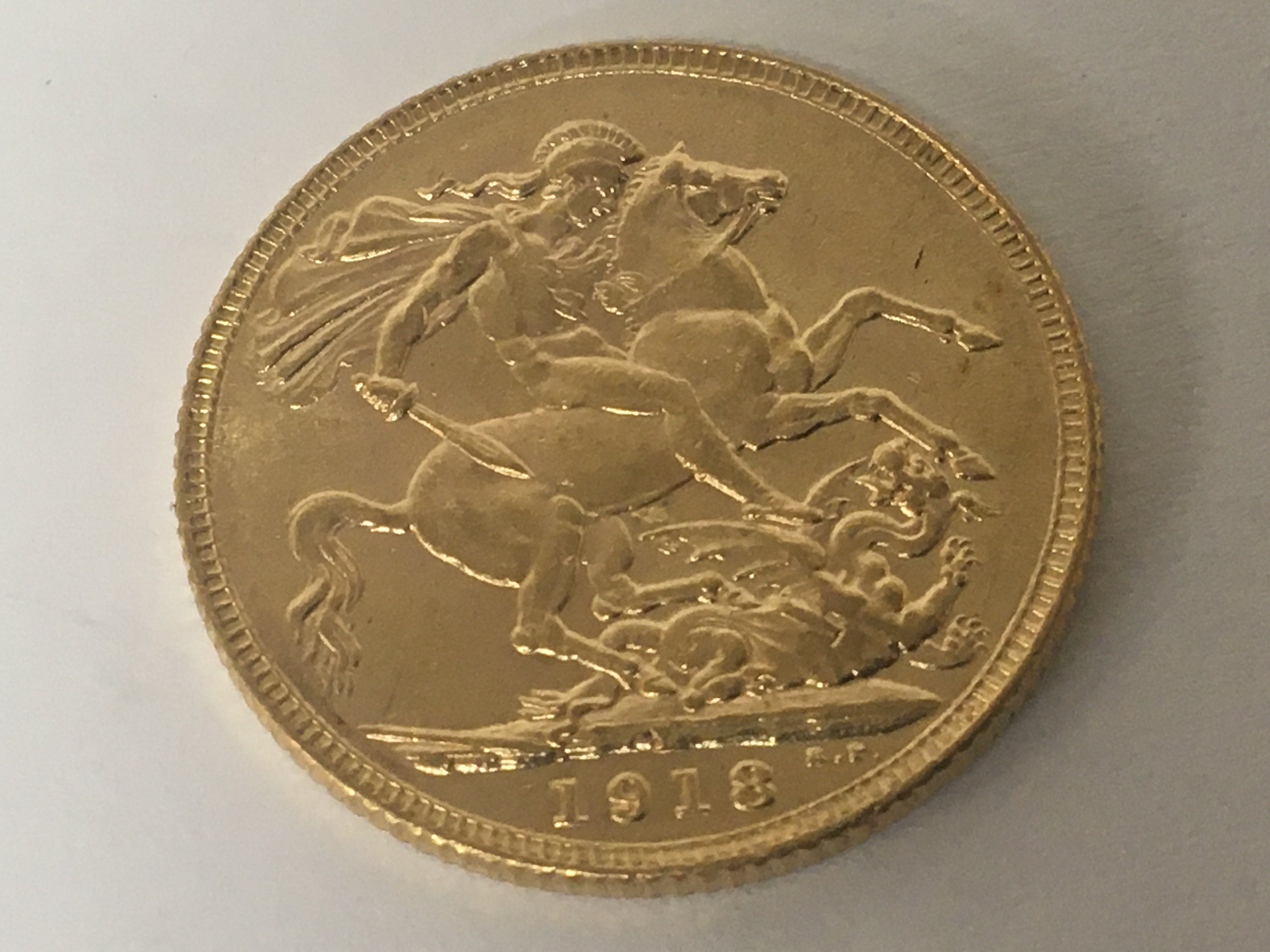 A Gold 1918 George V sovereign.